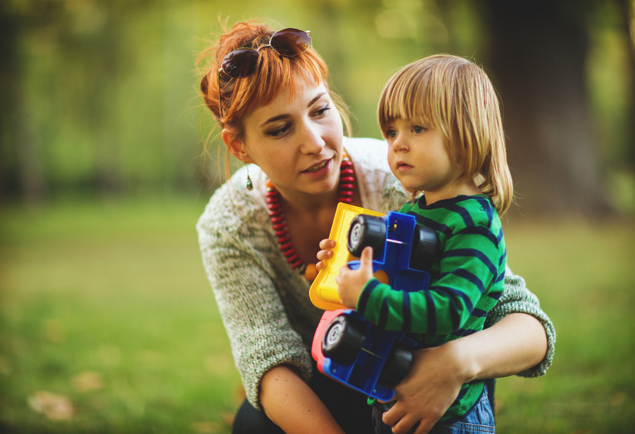 mom holding her child outside